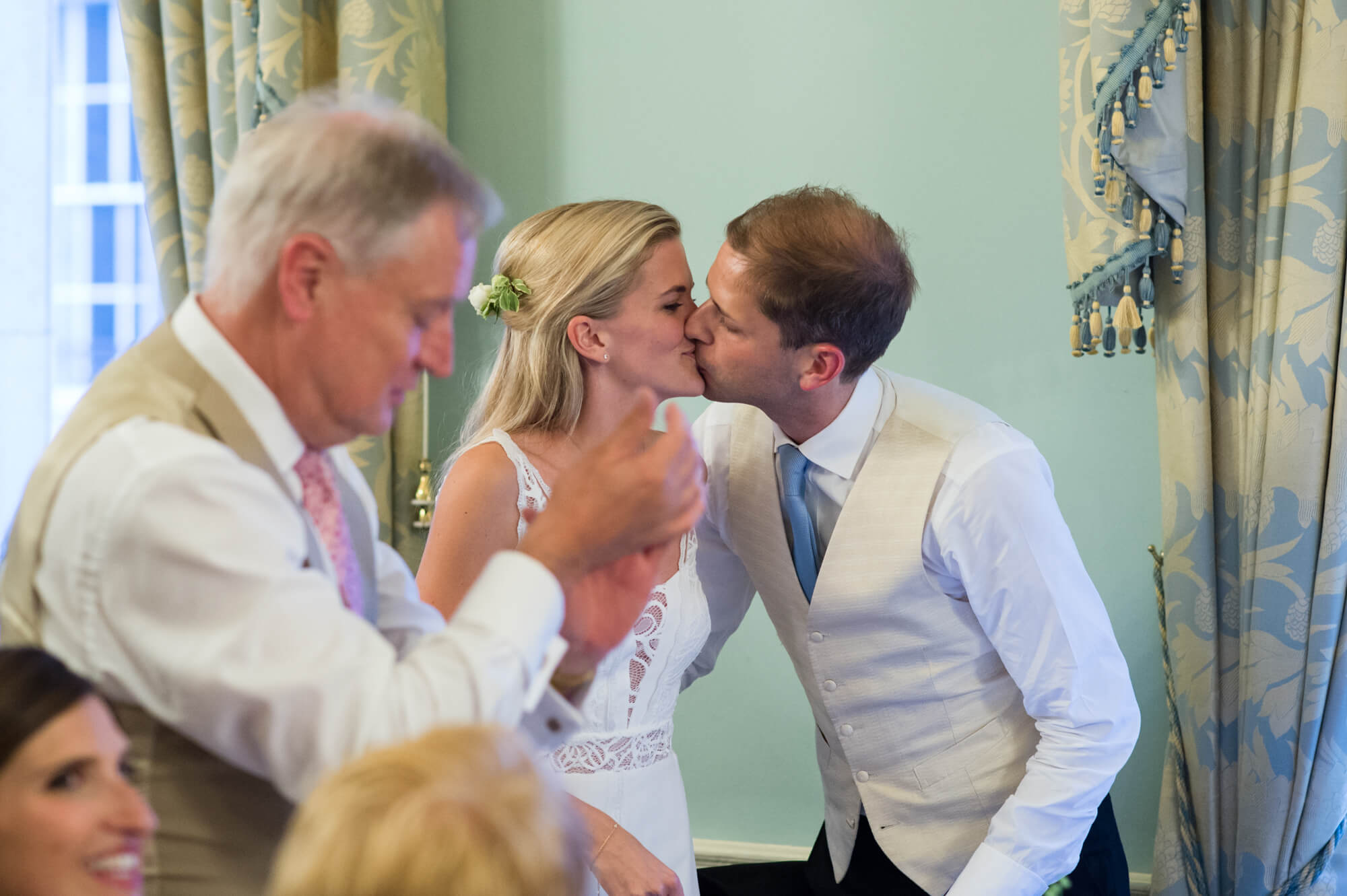 A bride and groom kissing at Dartmouth house